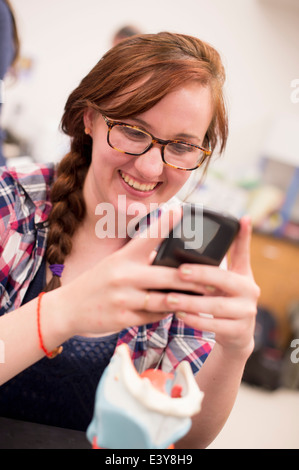 Biology student photographing anatomical model Stock Photo