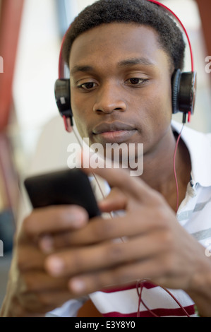 Young man using mp3 player Stock Photo
