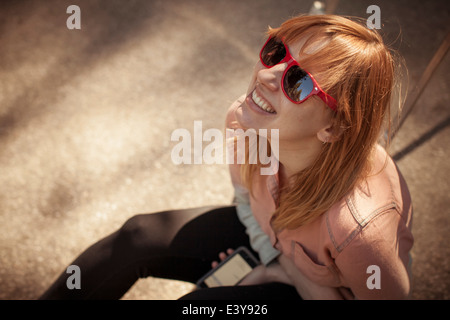 Candid portrait of mid adult woman in sunglasses gazing upward Stock Photo