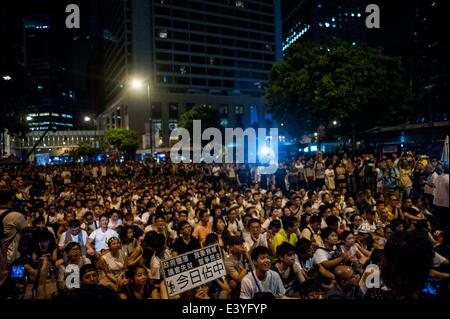 Hong Kong. 01st July, 2014. Demonstrators sit in a street of the central district after a pro-democracy rally seeking greater democracy in Hong Kong on July 01, 2014 as frustration grows over the influence of Beijing on the city.  Credit:  Xaume Olleros/Alamy Live News Stock Photo