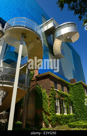 Blue titanium Art Gallery of Ontario AGO south wing with external stairways designed by Gehry over the Grange historic manor Toronto Stock Photo