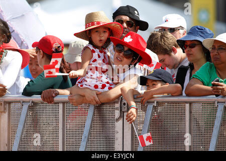 Ottawa, Canada. 1st July, 2014. A girl and her mom wait for the ceremonies to celebrate the 147th Canada Day on Parliament Hill in Ottawa, Canada, on July 1, 2014. Credit:  David Kawai/Xinhua/Alamy Live News Stock Photo