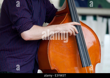 Man playing a double bass at Leamington Peace Festival, UK Stock Photo