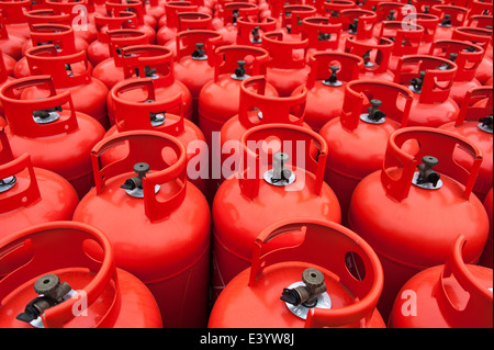 Details of red gas bottles stacked at a storage depot. Stock Photo