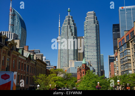 Gooderham Flatiron building with financial district bank towers L tower and CN tower at St Lawrence Market Toronto in summer with blue sky