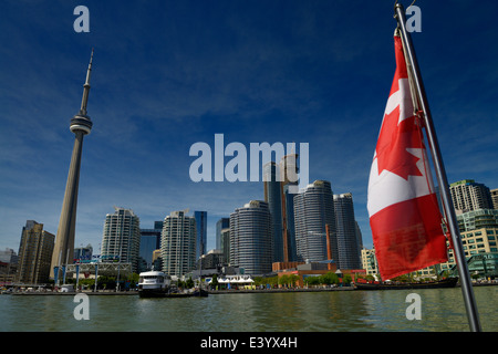 Canadian flag on a boat with Toronto skyline CN Tower and harbourfront on Lake Ontario Stock Photo