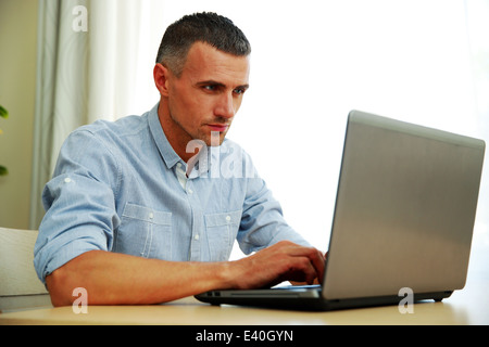 Handsome man using laptop Stock Photo