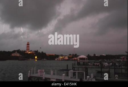 Hope Town, Abaco, Bahamas. 2nd July, 2014. Lightening flashes near the 150 year-old lighthouse in Hope Town. Tropical Storm Arthur has been pounding the East coast of Florida and the Islands of the Bahamas with gusty winds and thunderstorms delaying flights, and making passage on boats a bit bumpy. Photos shot before sunrise between 5:30AM and 6:30AM. Sidney Bruere/Alamy Live News Stock Photo