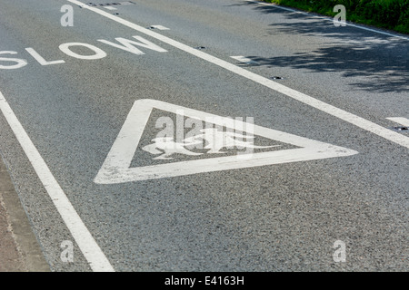 School warning sign on road showing pictogram of girl and boy walking to school pictogram. Metaphor returning to school, new term, term starting. Stock Photo
