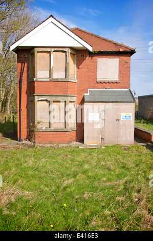 Boarded up and abandoned detached house in rural area Stock Photo
