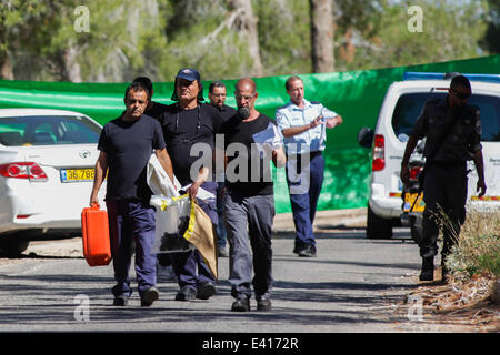 Jerusalem. 2nd July, 2014. Investigators work near the crime scene where an Arab teen was found dead in the Jerusalem Forest, July 2, 2014. Early on Wednesday morning, police found a body of an Arab youth in the Jerusalem Forest. The police suspect the murder was done as a revenge for the murder of three Israeli teens. Micky Rosenfeld, a spokesperson for the police, told Xinhua that the body was found about an hour after the police received a report on abduction of an Arab teenager from Jerusalem. Credit:  Xinhua/Alamy Live News Stock Photo