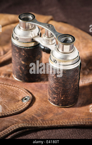 Close up of old fashioned binoculars on leather cap. Stock Photo