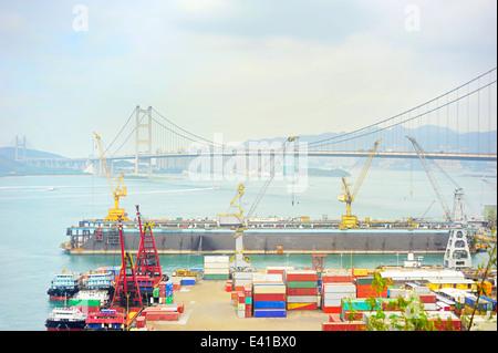 Hong Kong comercial container port . Tsing Ma bride on background Stock Photo