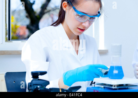 girl laboratory assistant checks samples in a medical lab Stock Photo