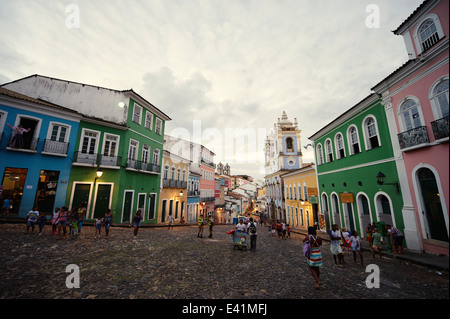 SALVADOR, BRAZIL - OCTOBER 12, 2013: Tourists and locals mix in a plaza as dusk falls over the historic city center Pelourinho Stock Photo