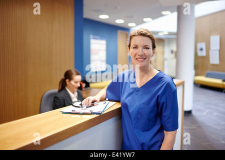 Nurse standing in hospital waiting room Stock Photo