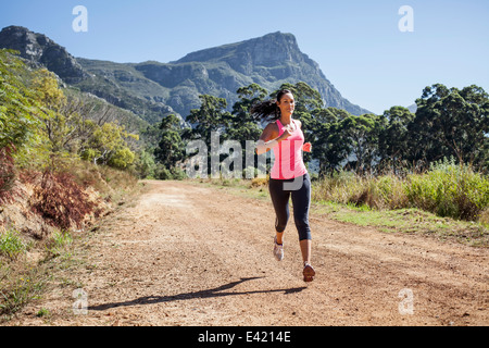 Young woman jogging in forest Stock Photo