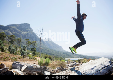 Male jogger jumping in mid air Stock Photo