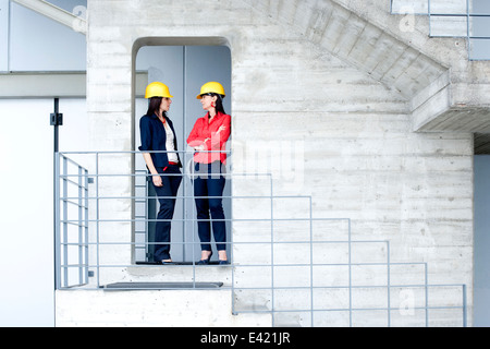 Businesswomen in safety helmet at balcony Stock Photo