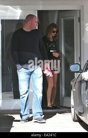 Taylor Swift leaving Ballet Bodies after a workout. Swift was spotted leaving the studio while still wearing her ballet shoes, accompanied by a large bodyguard.  Featuring: Taylor Swift Where: Los Angeles, California, United States When: 06 Jan 2014 Stock Photo