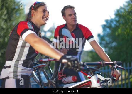 Cyclists taking break in park Stock Photo