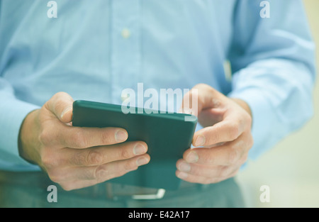 Male hands holding digital tablet Stock Photo