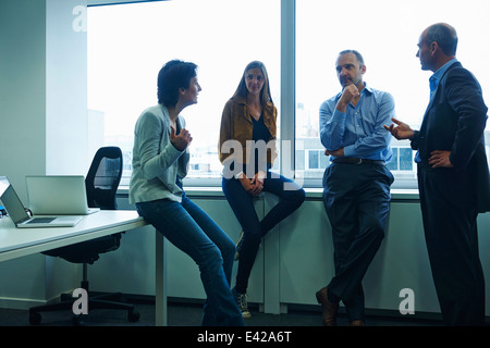 Businesspeople chatting in office Stock Photo