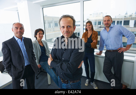 Businesspeople posing for group portrait in office Stock Photo
