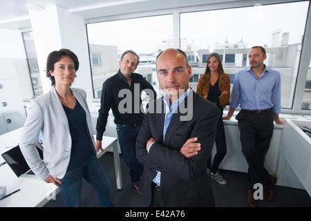 Businesspeople posing for group portrait in office Stock Photo