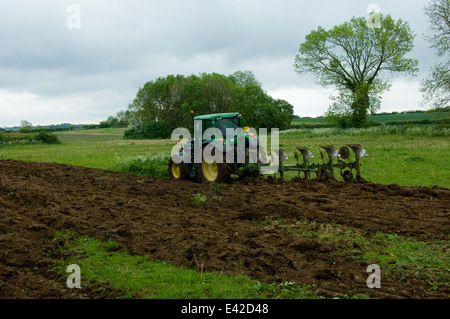 Tractor ploughing field Stock Photo