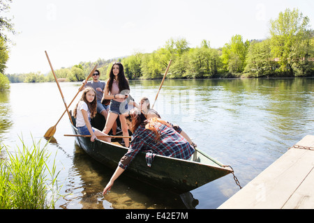 Group of friends in a row boat Stock Photo