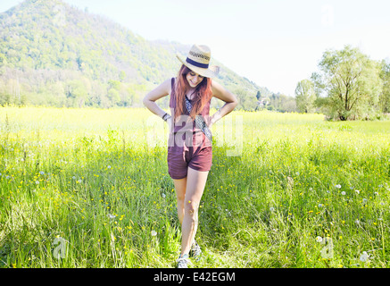 Young woman standing in field Stock Photo