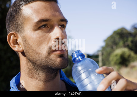 Man holding up water bottle Stock Photo