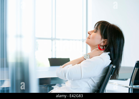 Businesswoman resting in meeting room Stock Photo