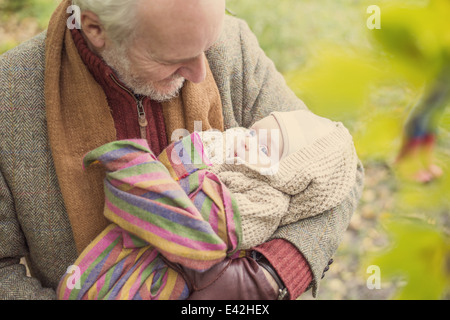 Grandfather cradling grandson, high angle Stock Photo