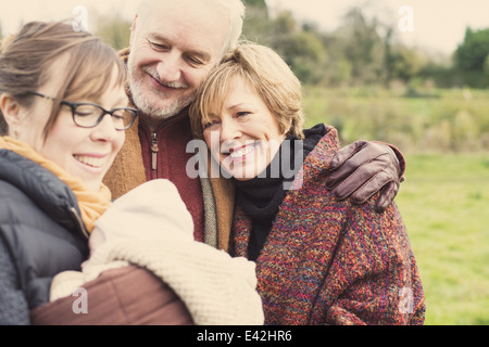Mother holding baby son, with grandparents Stock Photo