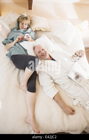 Couple lying on bed relaxing Stock Photo