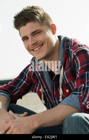 Portrait of young man wearing checked pattern shirt Stock Photo