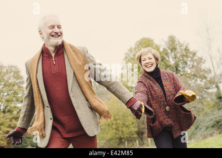 Couple holding hands in garden Stock Photo