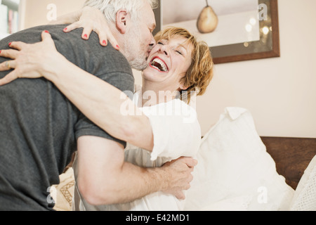 Couple hugging, mature woman laughing Stock Photo