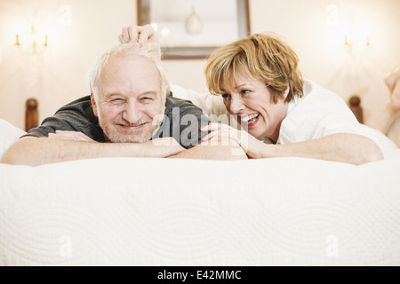 Couple lying on bed, portrait Stock Photo