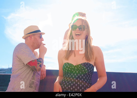 Three adult friends laughing on board yacht Stock Photo