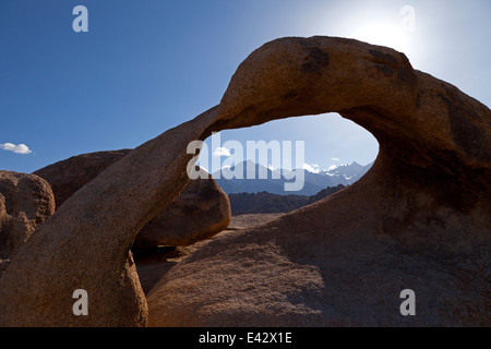 Lone Pine Peak and Mount Whitney seen through Mobius Arch in California's Alabama Hills State Recreation Area at night. Stock Photo