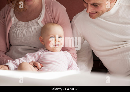 Cropped portrait of baby girl and mid adult parents Stock Photo