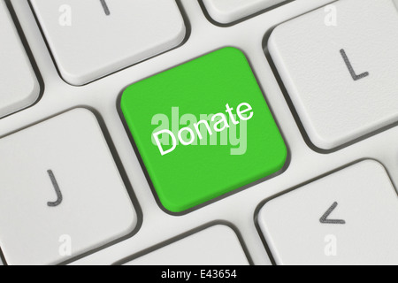 Green donate button on the keyboard close-up Stock Photo