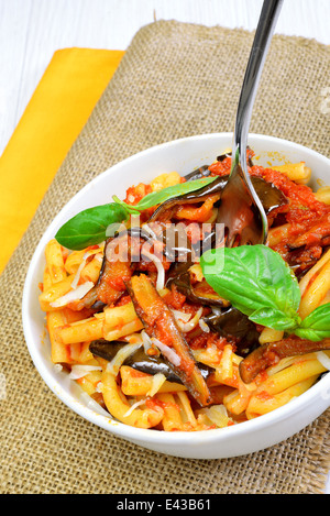 italian sicilian homemade pasta with eggplant and pecorino cheese and tomato sauce called 'pasta alla norma' Stock Photo