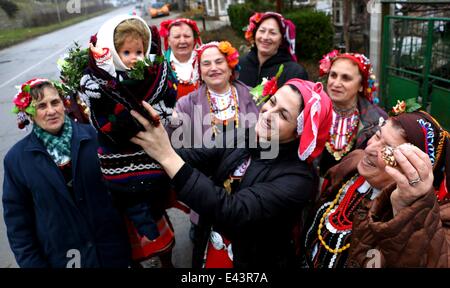 Bulgarian women dressed up for a carnival perform in celebration of the Midwives' Day in the village of Topoli east of the Bulgarian capital Sofia. Midwives' Day is one of the most popular holiday in Bulgaria and it is a patron of the women who work as do Stock Photo