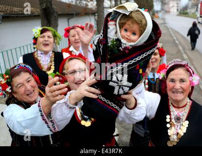 Bulgarian women dressed up for a carnival perform in celebration of the Midwives' Day in the village of Topoli east of the Bulgarian capital Sofia. Midwives' Day is one of the most popular holiday in Bulgaria and it is a patron of the women who work as do Stock Photo