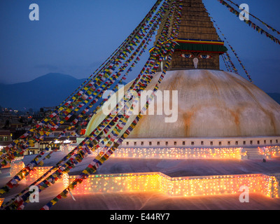 Buddhist shrine Boudhanath Stupa with pray flags over sunset sky. Nepal, Kathmandu Stock Photo