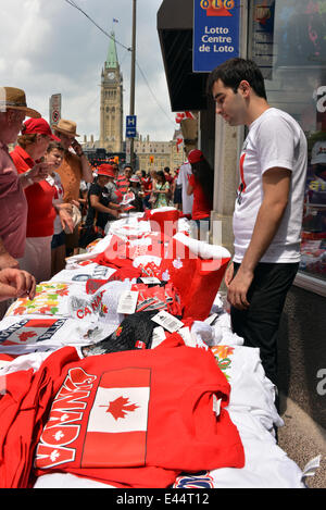 Ottawa, Canada. July 1st, 2014.  Vendor sells Canada related goods to the thousands of people who visit Parliament Hill in Ottawa for Canada Day. © Paul McKinnon/Alamy Live News Stock Photo